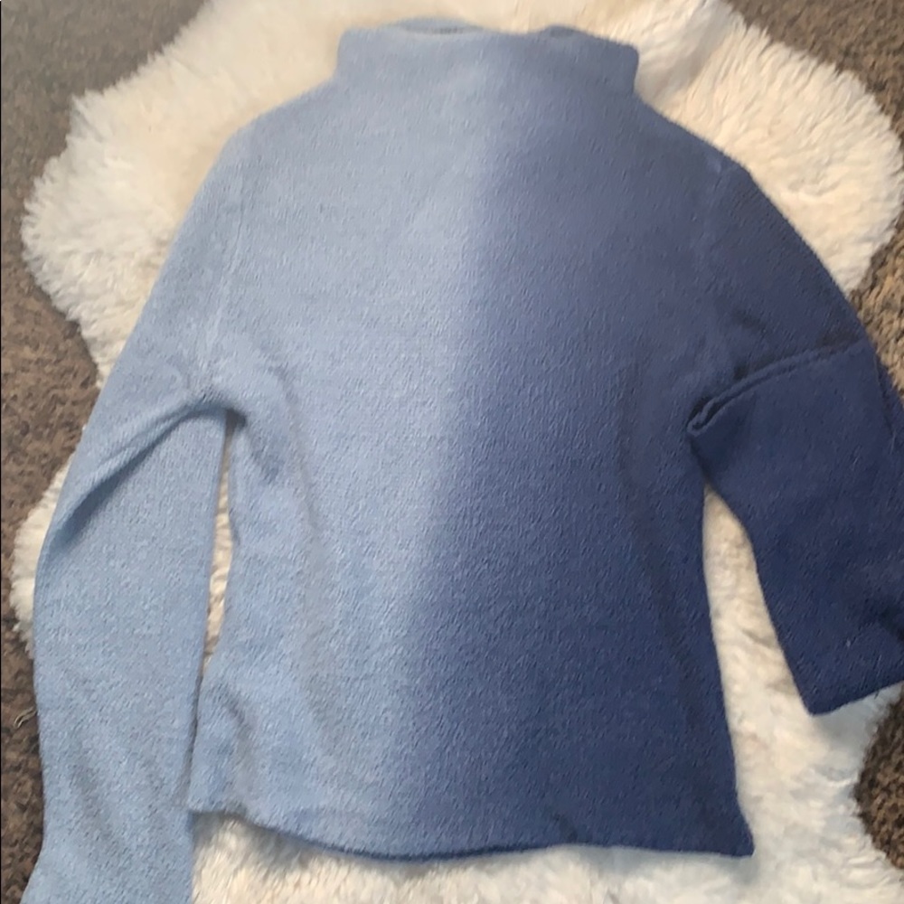 Faded from light blue to a darker blue sweater